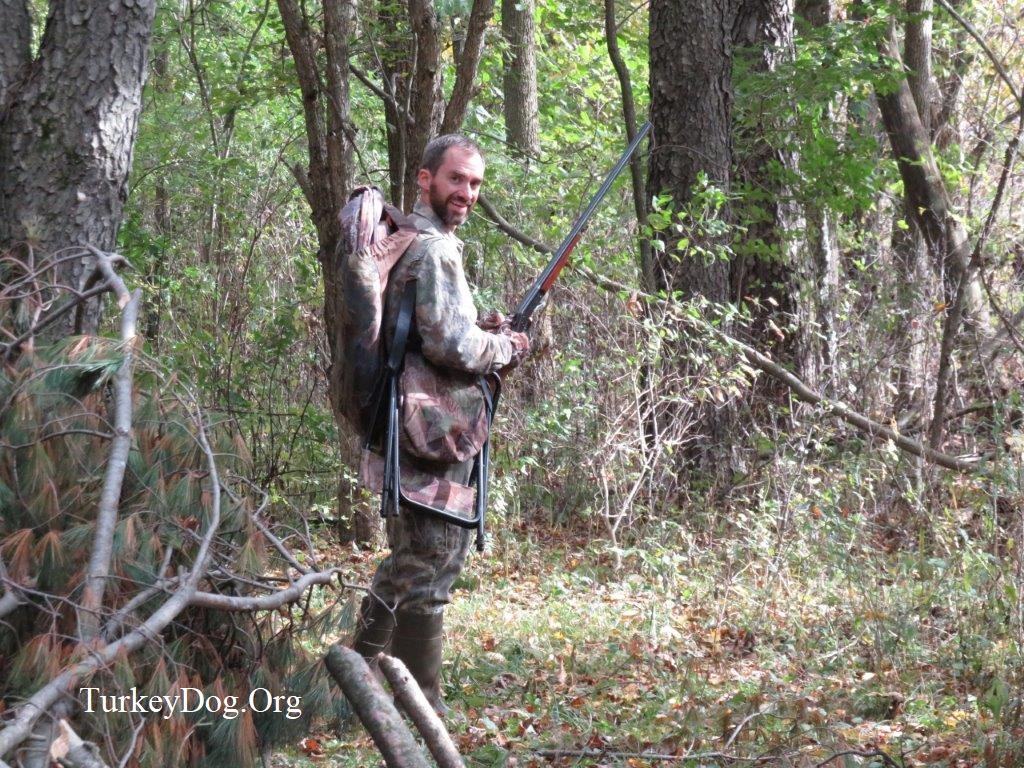 Fall turkey hunter carrying a blind and chair.